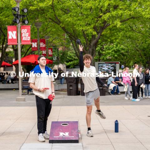 Max Booher (left) and Daniel Koland (right), members of Pi Kappa Alpha, play a game of corn hole at the lunch and gear check-out for the Big Event. May 4, 2024. Photo by Kirk Rangel for University Communication.